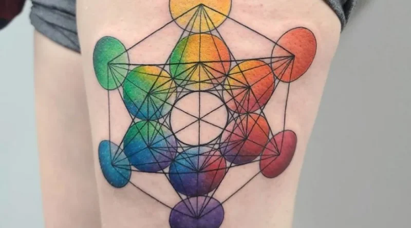 Tattoo artist sketching a geometric mandala design on paper with a compass and ruler.