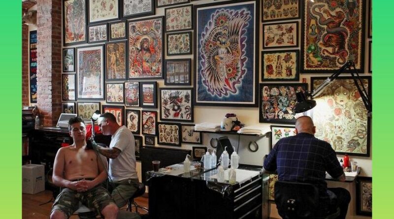 Artist completing a tattoo convention application form online.