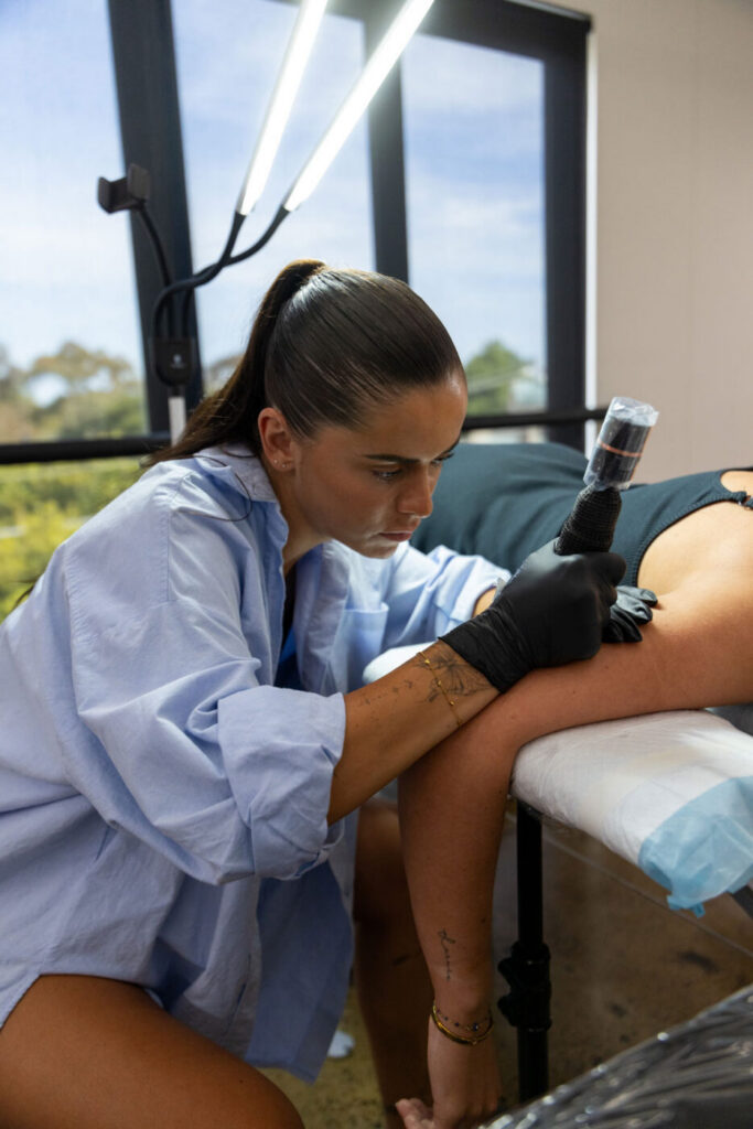Fine line tattoo on the ribcage, a placement affected by breathing movement.