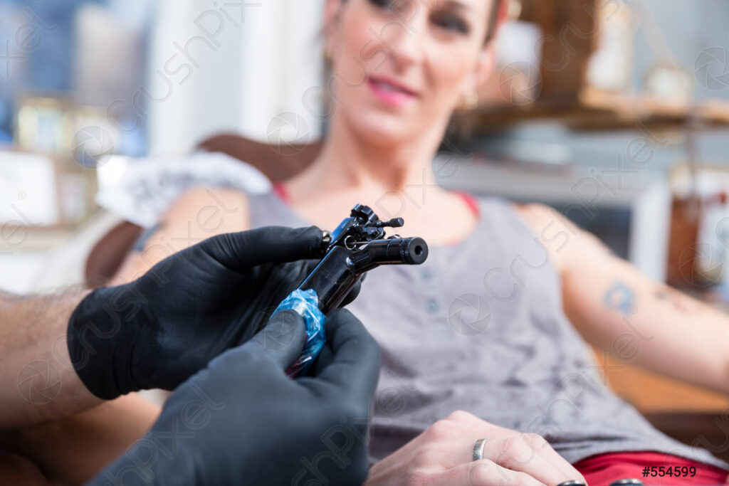 Tattoo artist preparing sterile equipment in a clean, well-lit studio