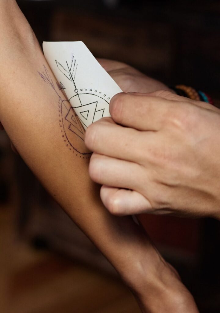 Fresh tattoo covered with transparent adhesive bandage