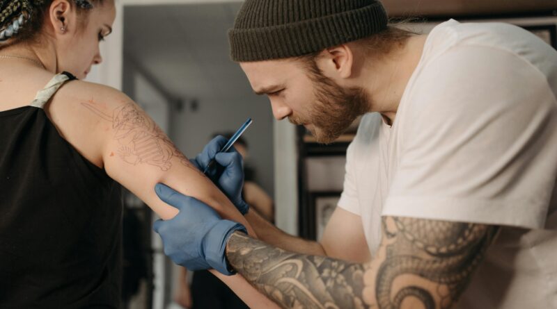 Tattoo artist preparing a client for a session