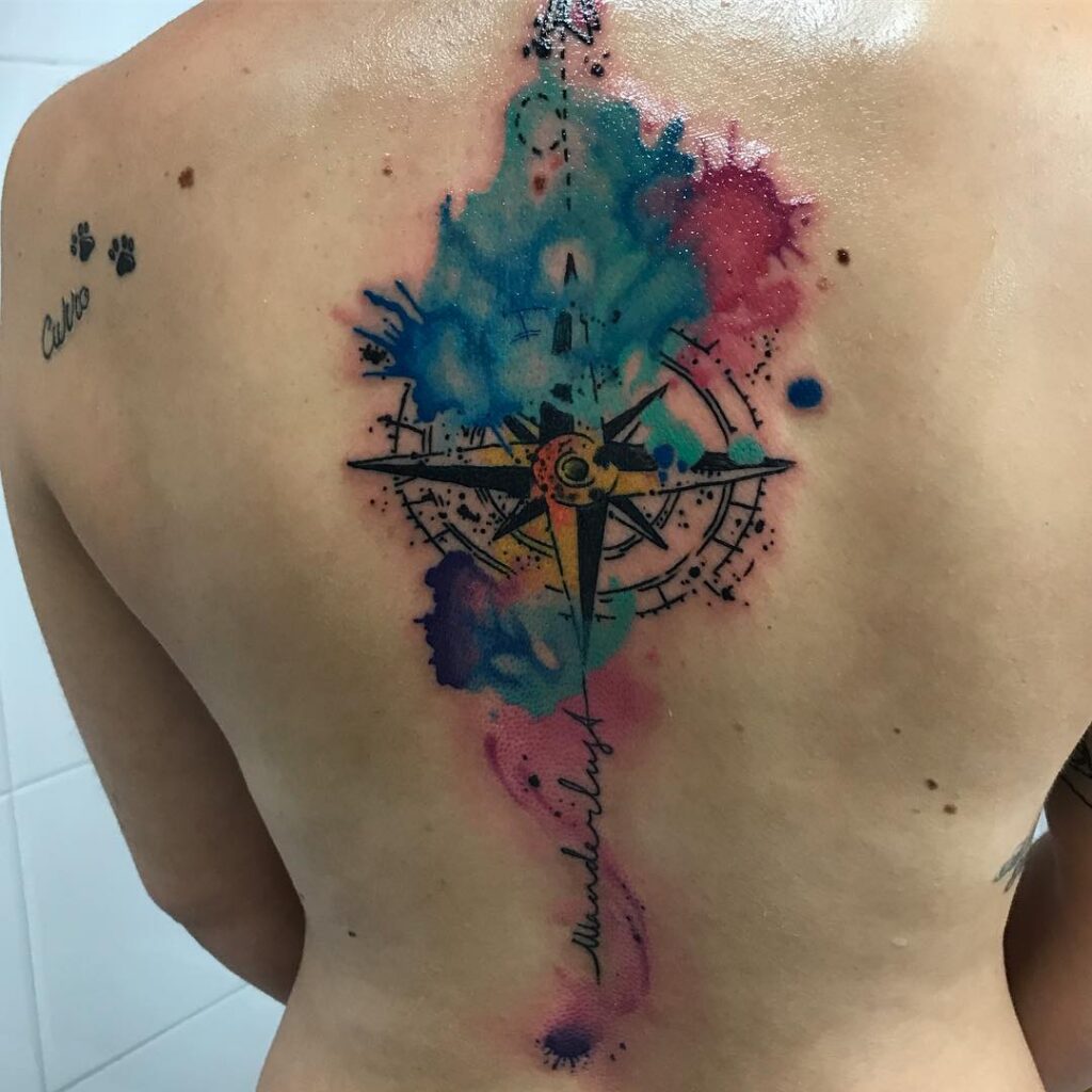 A tattoo artist applying a stencil on a client's arm before tattooing.