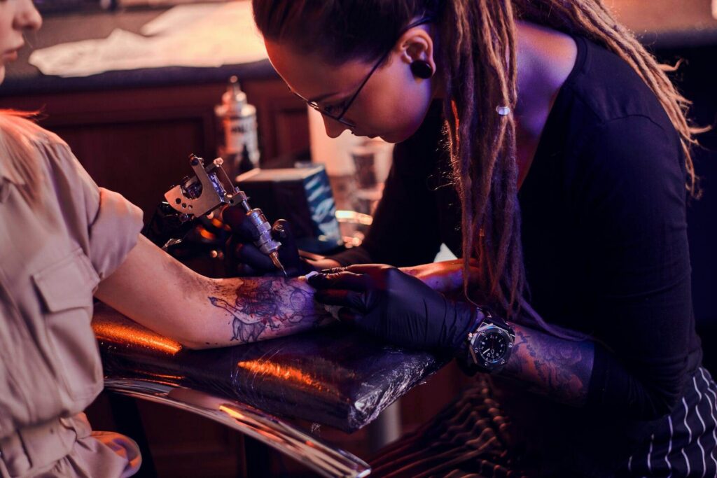 Close-up of a blackwork tattoo on forearm with solid black shading