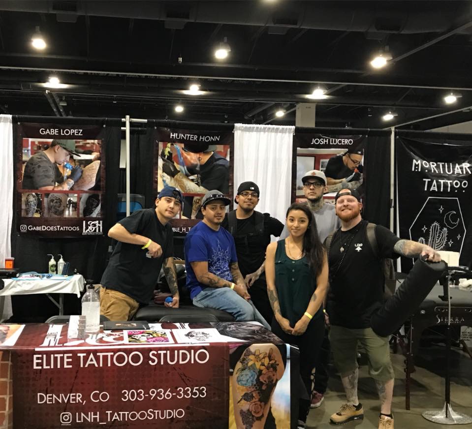 A tattoo artist working a guest spot at a convention booth