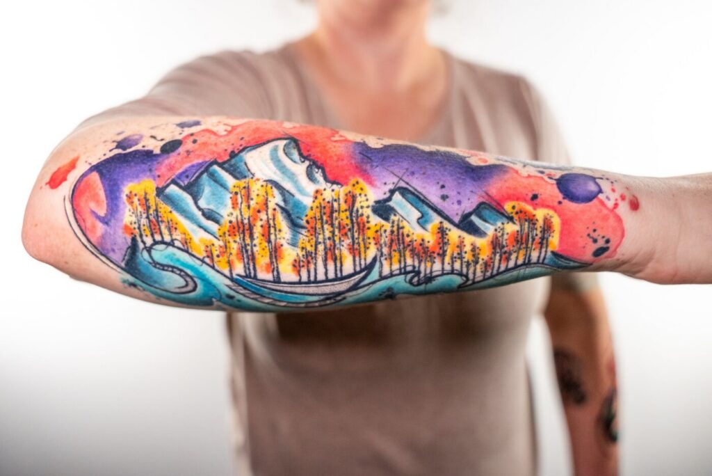 Artist applying a small color test patch on client's skin before the full tattoo.