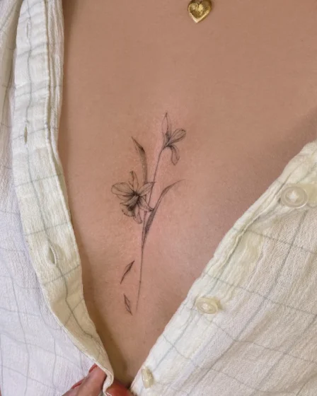 Close-up of a tattoo machine with a fine line needle.
