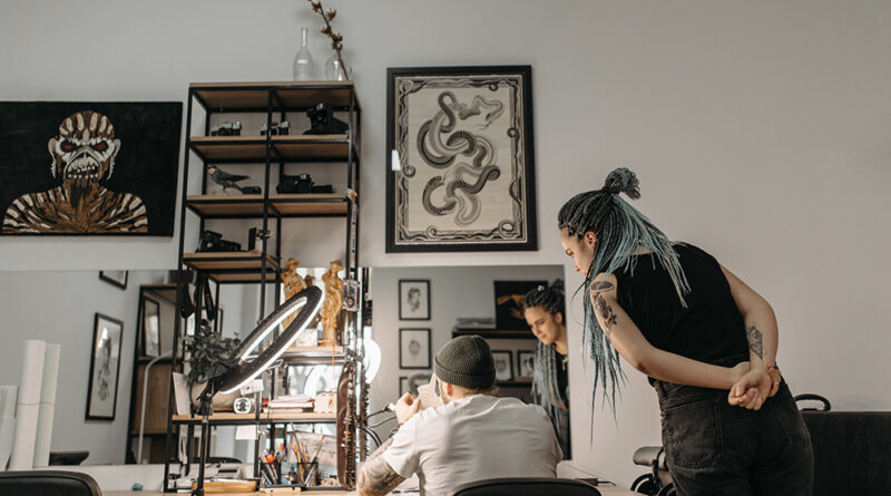 A tattoo consultation desk with design sketches and an appointment book.