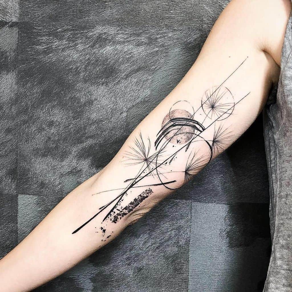 A tattoo artist meticulously applying a fine line design using a single needle.