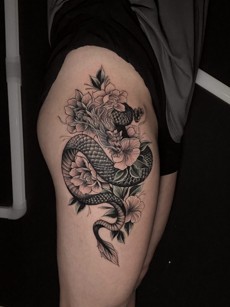 Geometric blackwork tattoo with negative space creating a face profile.