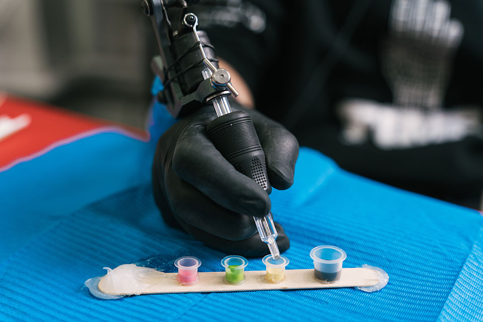Tattoo ink bottles stored in a refrigerator to maintain stability