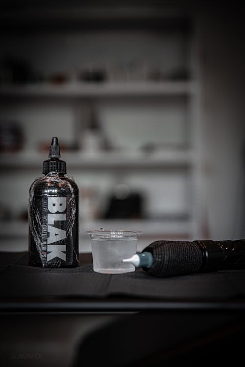 Tattoo consultation between artist and client discussing design