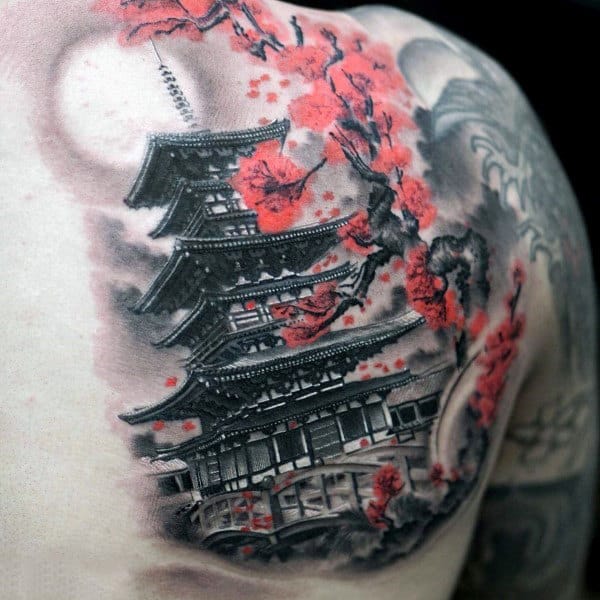 A tattoo artist carefully placing a stencil on a client's arm before starting a Japanese traditional piece.
