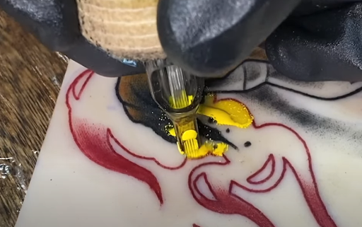 Tattoo artist opening a sealed sterile cartridge in front of the client to ensure hygiene.