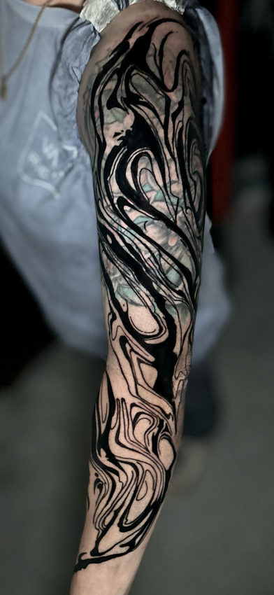 Blackwork mandala tattoo using dotwork technique on forearm.