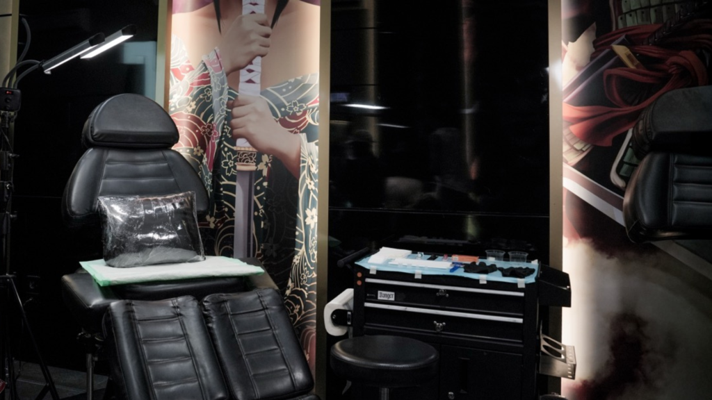 Reception area of a tattoo studio decorated with vinyl records and potted plants.