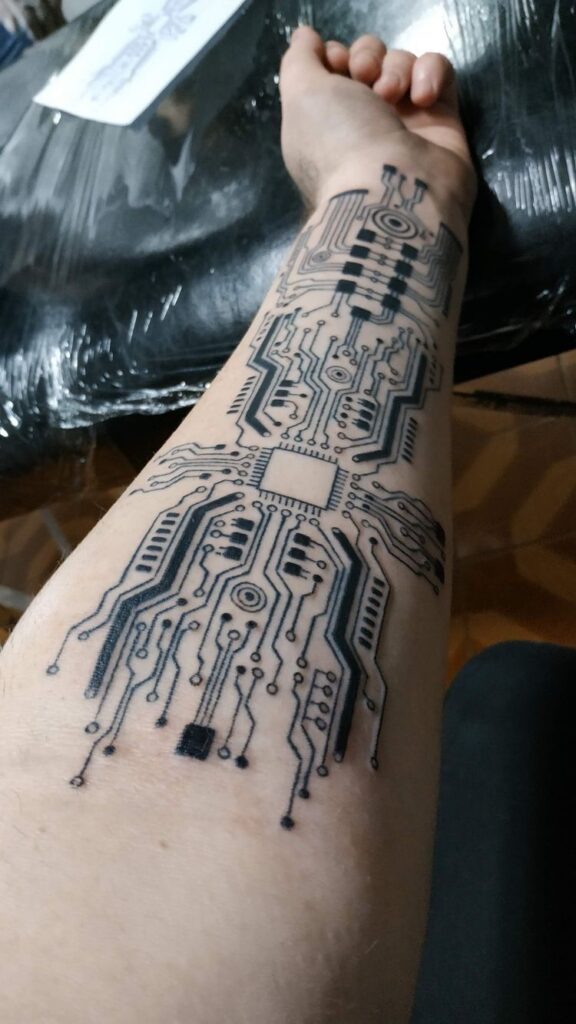 Fresh cyber sigilism tattoo covered with a transparent aftercare film wrap.