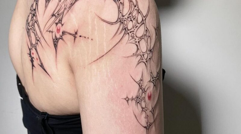 Tattoo artist carefully placing a stencil of a cyber sigilism design on a client's arm.