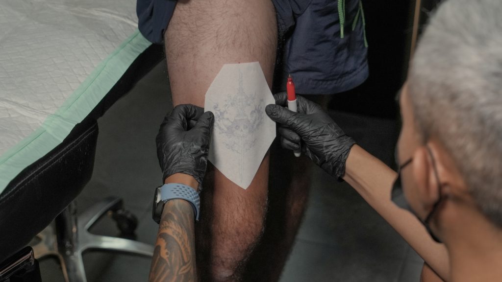 A tattoo of a traditional Dong Son drum pattern on an arm, honoring Vietnamese heritage.