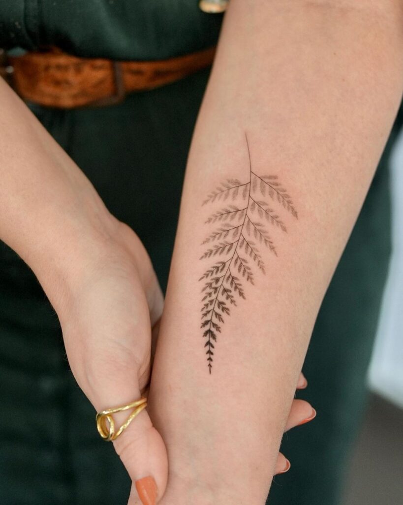 A large fine line botanical tattoo on the calf, with thick stems and varying line weights.