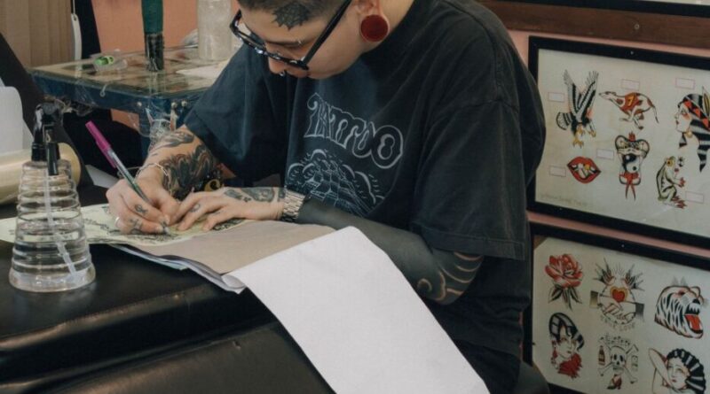 A bustling walk-in tattoo studio in Hanoi with a waiting area and flash sheets on the wall.