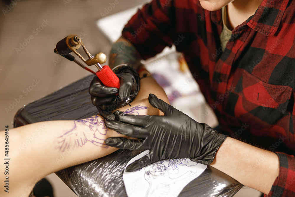 A healed traditional tattoo on a forearm, showing settled lines.