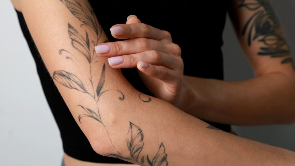 Examining fine line details on a healed tattoo.