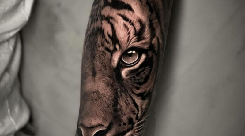Artist marking placement on the arm before tattooing