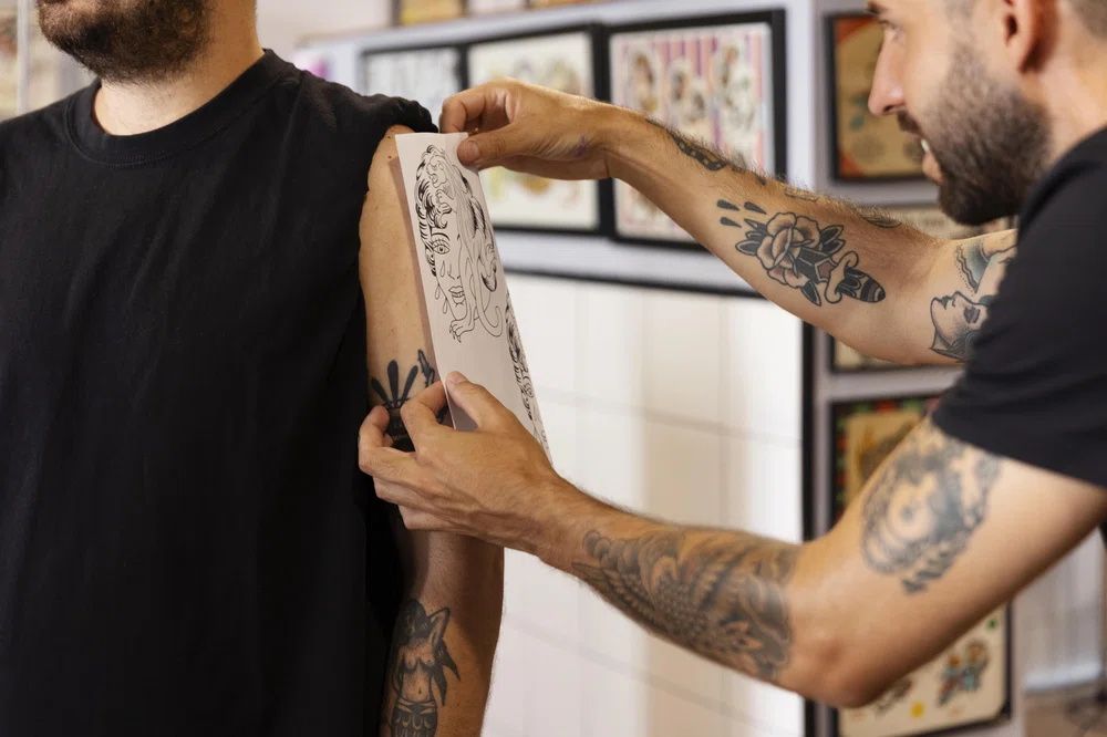Healed blackwork on an arm next to aftercare products, illustrating proper care.