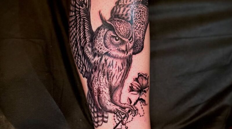 Placing a stencil on the forearm ensures the design follows the muscle.