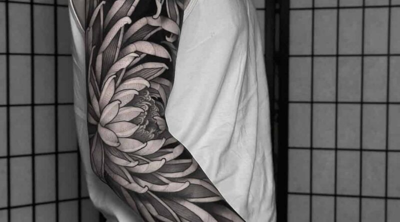 Graphic tattoo sleeve with collage composition and strong contrast