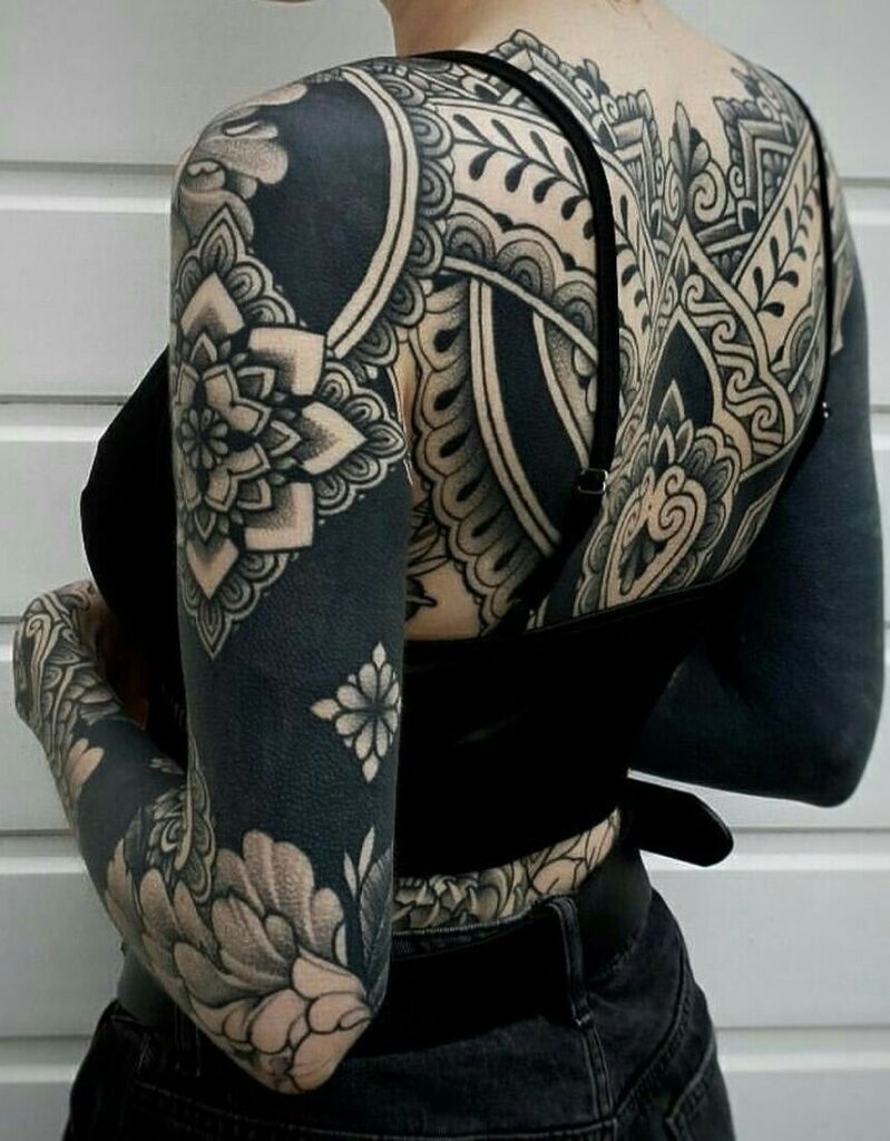 Tattoo artist consulting with client about ornamental design
