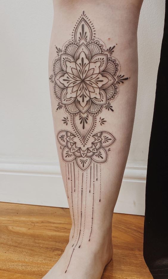 Artist sketching an ornamental tattoo design on paper