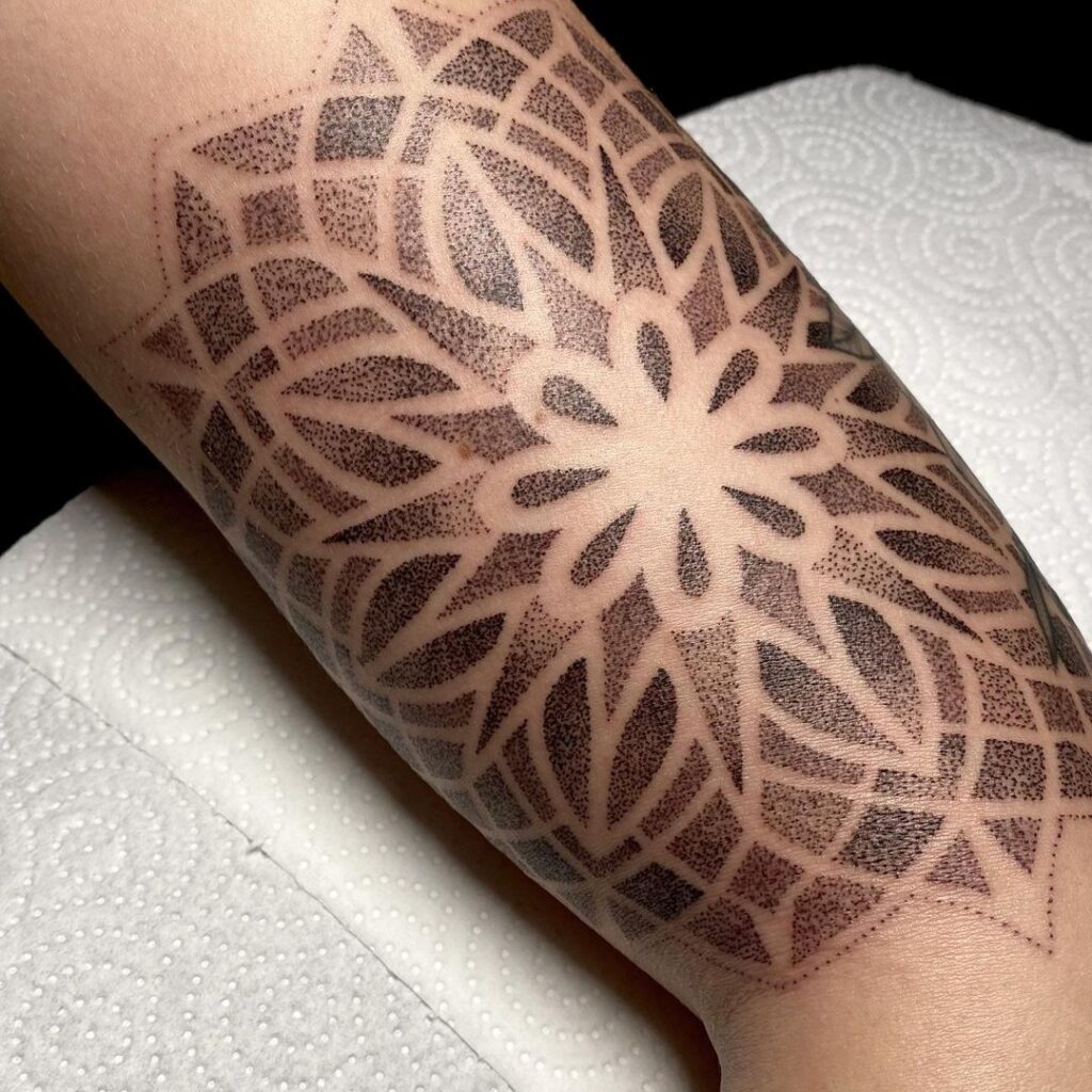 Healed ornamental tattoo on a leg photographed in natural light