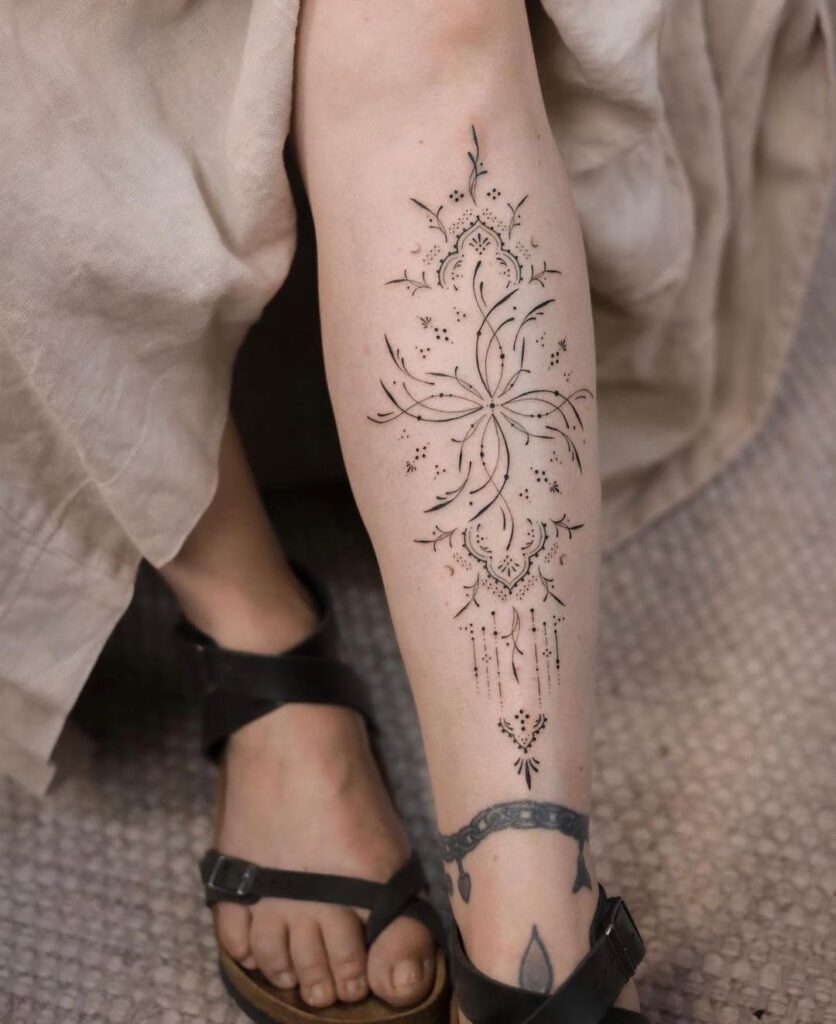Ornamental shoulder tattoo with prominent negative space