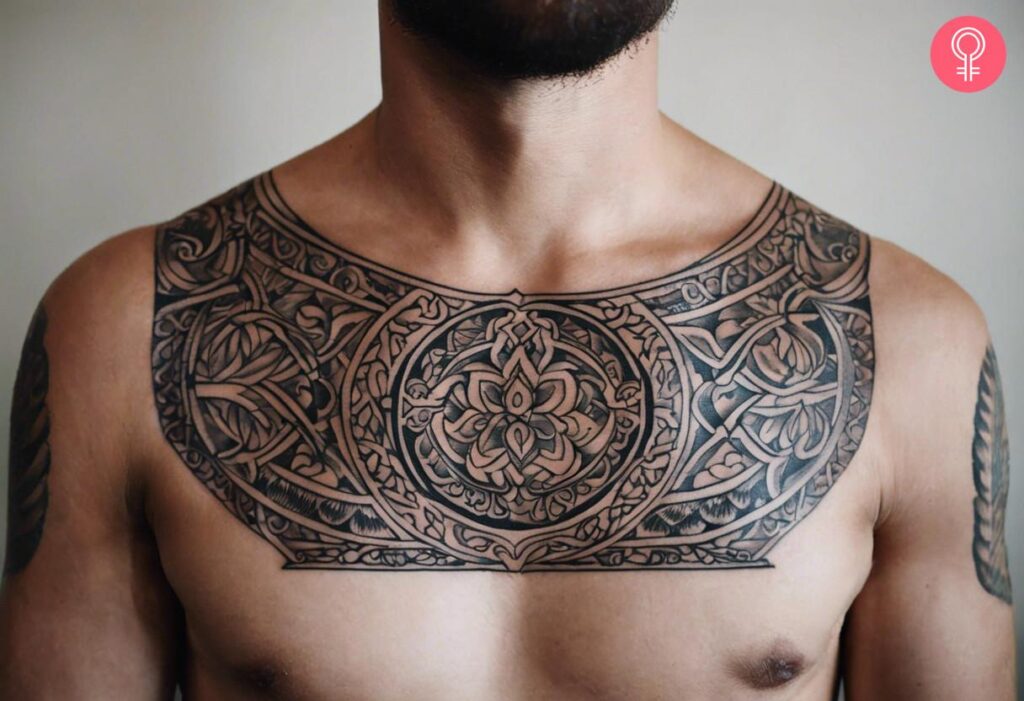 Symmetrical ornamental tattoo centered on the chest