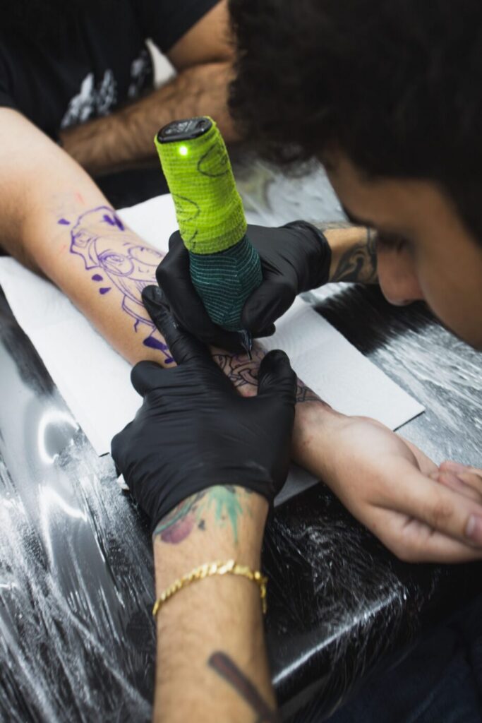 Tattoo artist applying a stencil on a client's back to ensure perfect alignment.