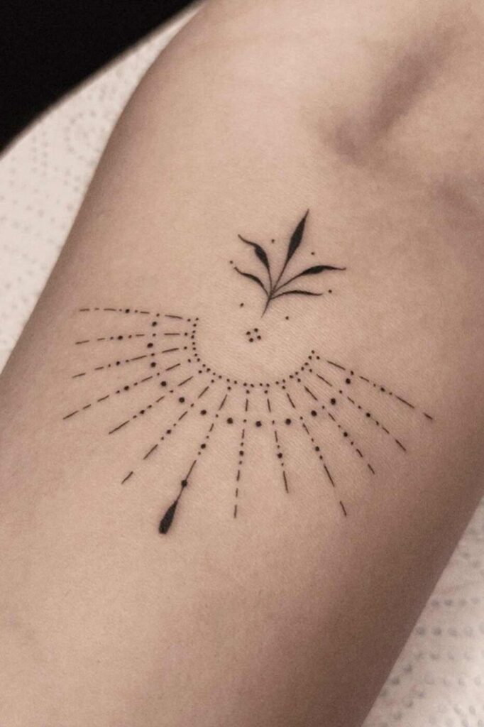 Ornamental shoulder tattoo with intentional negative space to create contrast.